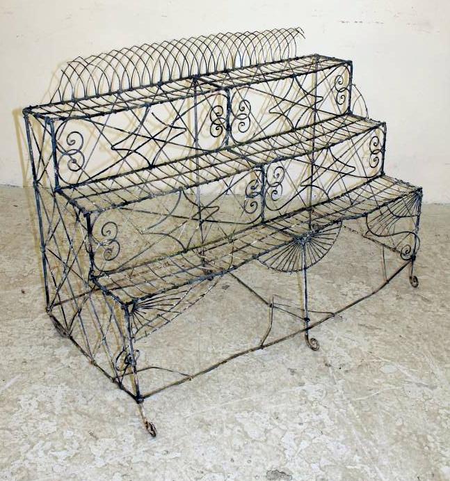 A VICTORIAN WIREWORK PLANT STAND of three tier oblong form with arched back Image