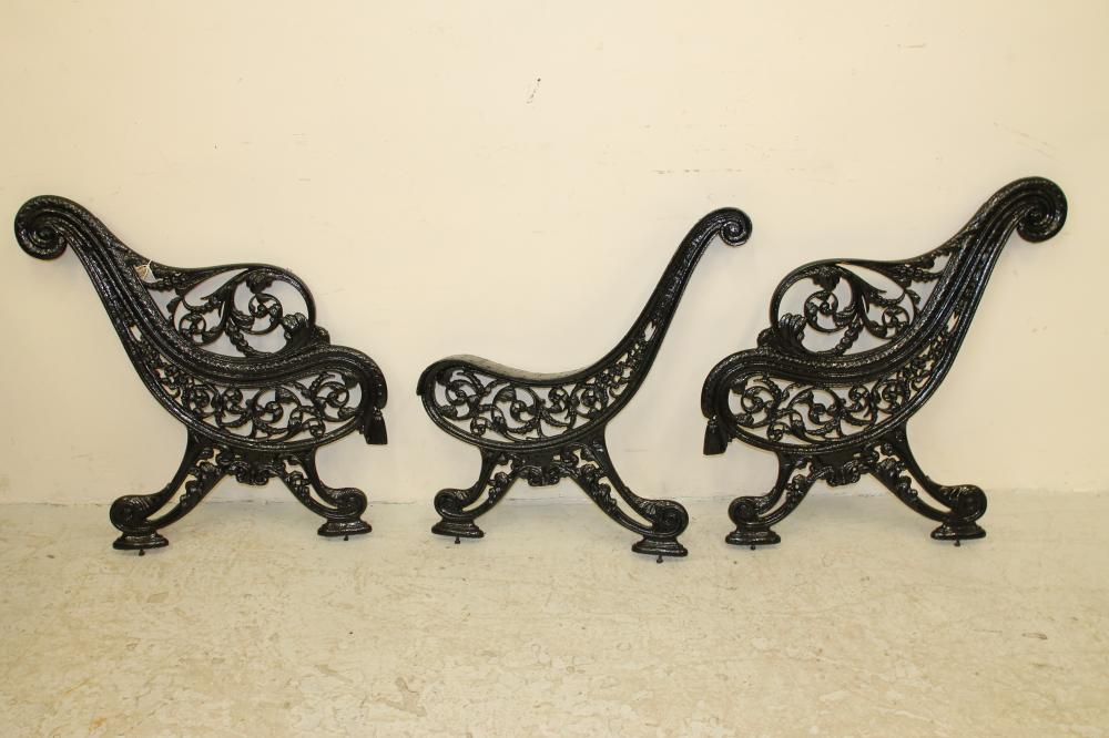 A PAIR OF VICTORIAN CAST IRON PARK BENCH ENDS and matching central support Image