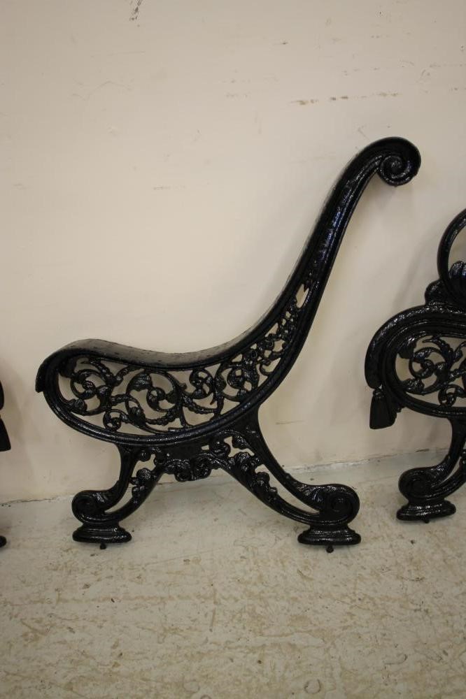 A PAIR OF VICTORIAN CAST IRON PARK BENCH ENDS and matching central support Image