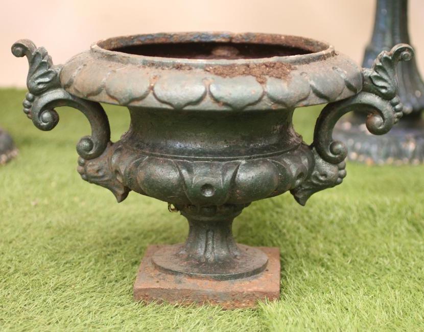 A SMALL VICTORIAN CAST IRON URN of campana form with leaf moulded rim and scrolled handle Image
