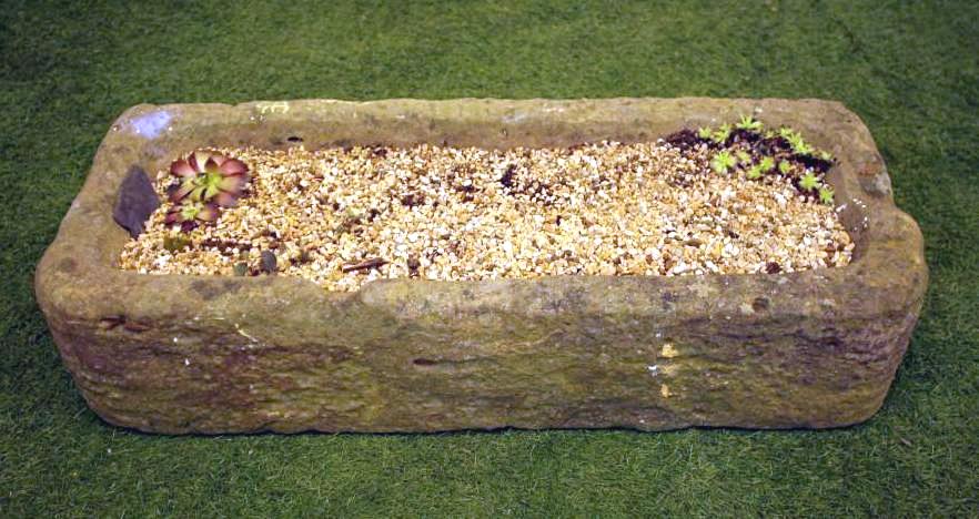A SANDSTONE TROUGH of narrow rounded oblong form Image