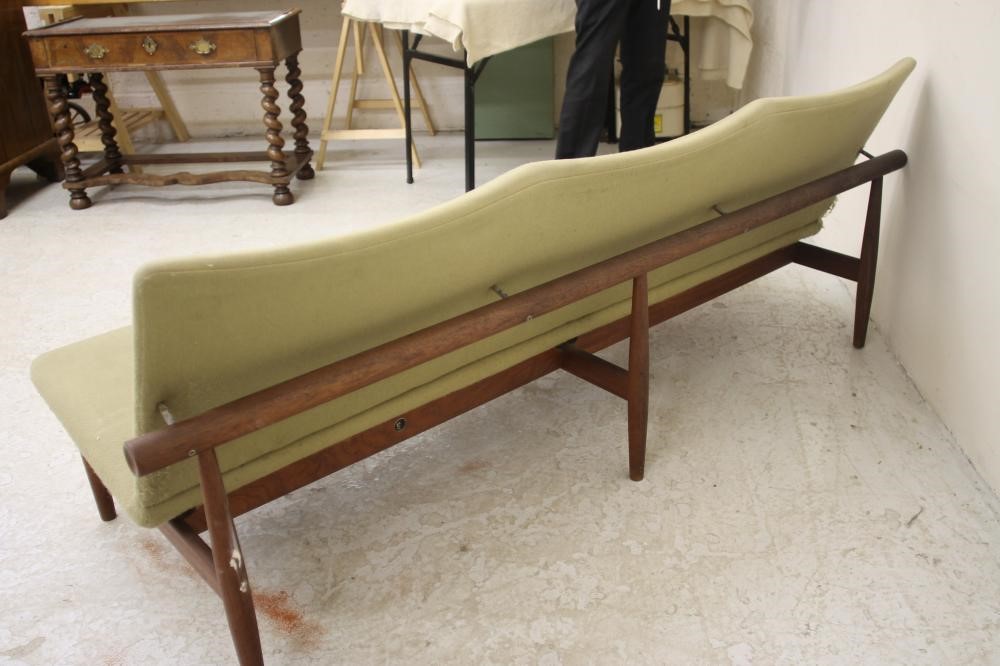 A DANISH TEAK FRAMED THREE SEATER SOFA upholstered in a pale green weave Image