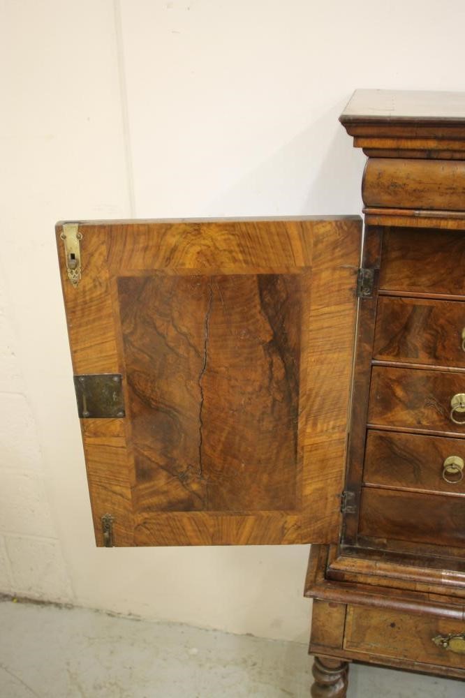 A WILLIAM & MARY WALNUT AND FEATHER BANDED CABINET ON STAND Image