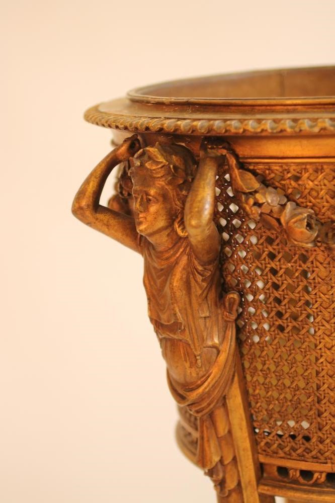 A CARVED GILT WOOD AND CANED JARDINIERE STAND Image