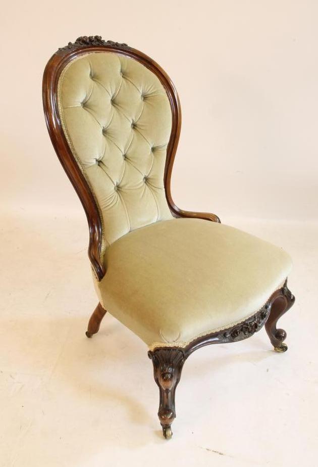 A LADY'S VICTORIAN CARVED WALNUT EASY CHAIR of spoon back form button upholstered in pale green Image