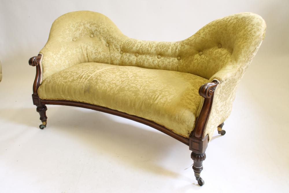 A VICTORIAN WALNUT FRAMED THREE SEATER SOFA of double spoon back form button upholstered in yellow Image