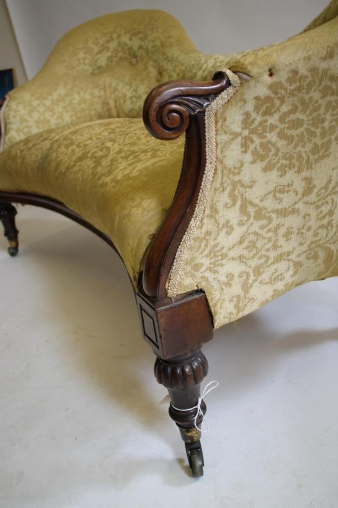 A VICTORIAN WALNUT FRAMED THREE SEATER SOFA of double spoon back form button upholstered in yellow Image