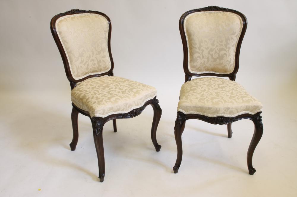 A PAIR OF VICTORIAN CARVED ROSEWOOD SIDE CHAIRS upholstered in champagne damask Image
