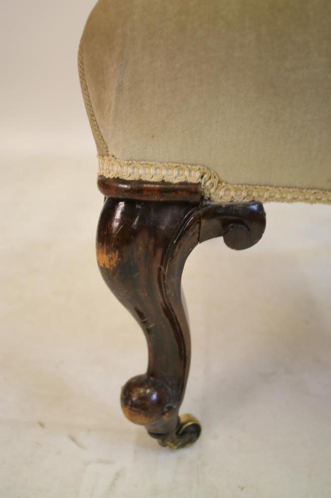 A VICTORIAN CARVED WALNUT FRAMED ARMCHAIR of spoonback form button upholstered in pale green dralon Image