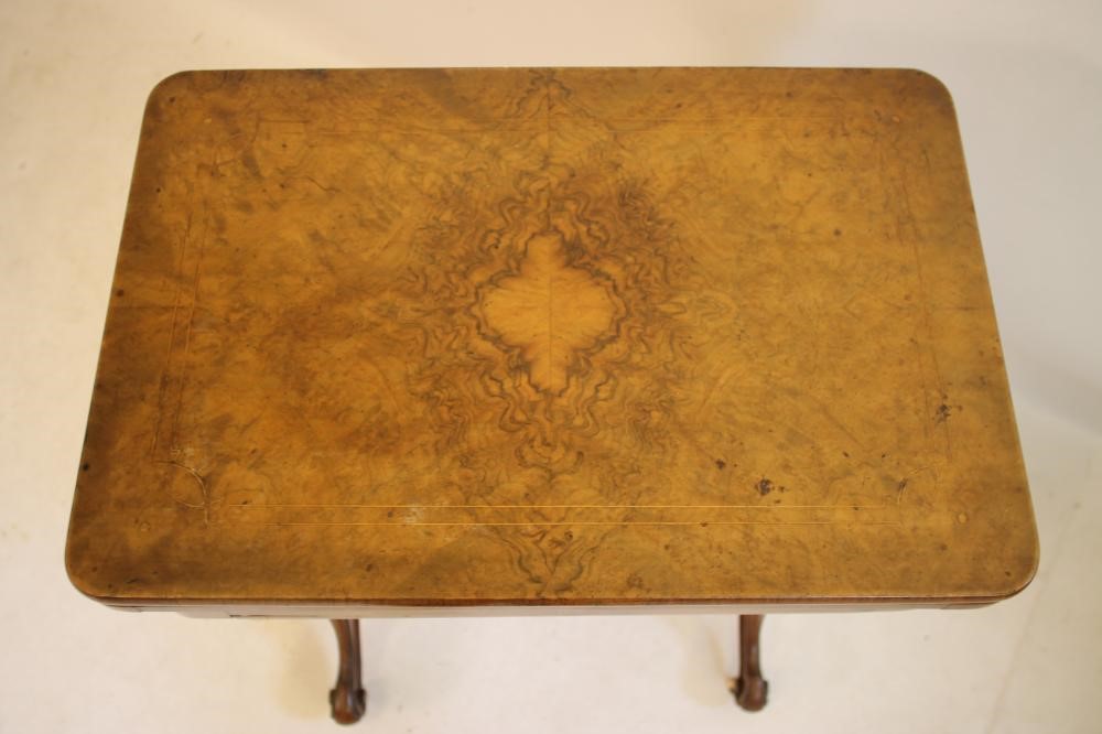 A VICTORIAN BURR WALNUT SEWING/CARD TABLE of rounded oblong form with inlaid floral sprays and Image