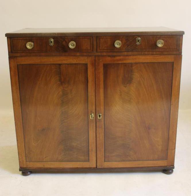 A REGENCY MAHOGANY AND EBONY STRUNG CABINET being the lower half of a bookcase Image