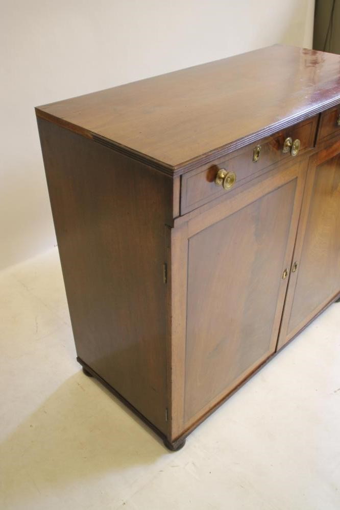 A REGENCY MAHOGANY AND EBONY STRUNG CABINET being the lower half of a bookcase Image