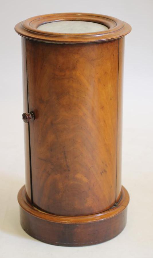A VICTORIAN MAHOGANY POT CUPBOARD of cylindrical form with inset white marble top Image