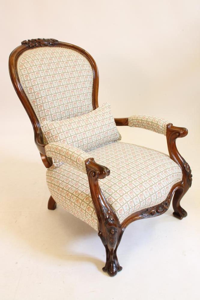 A VICTORIAN WALNUT ARMCHAIR of spoonback form upholstered in a modern pale green floral weave Image