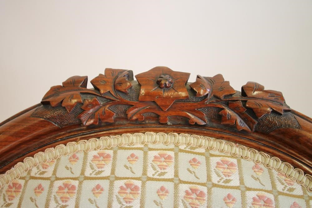 A VICTORIAN WALNUT ARMCHAIR of spoonback form upholstered in a modern pale green floral weave Image