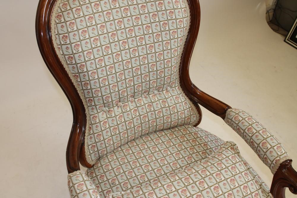 A VICTORIAN WALNUT ARMCHAIR of spoonback form upholstered in a modern pale green floral weave Image