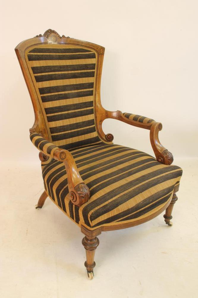 A VICTORIAN WALNUT ARMCHAIR of spoonback form with stringing and marquetry paterae Image