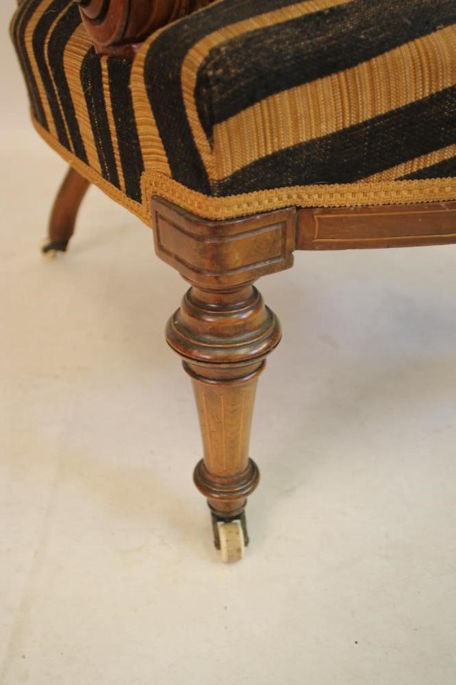 A VICTORIAN WALNUT ARMCHAIR of spoonback form with stringing and marquetry paterae Image