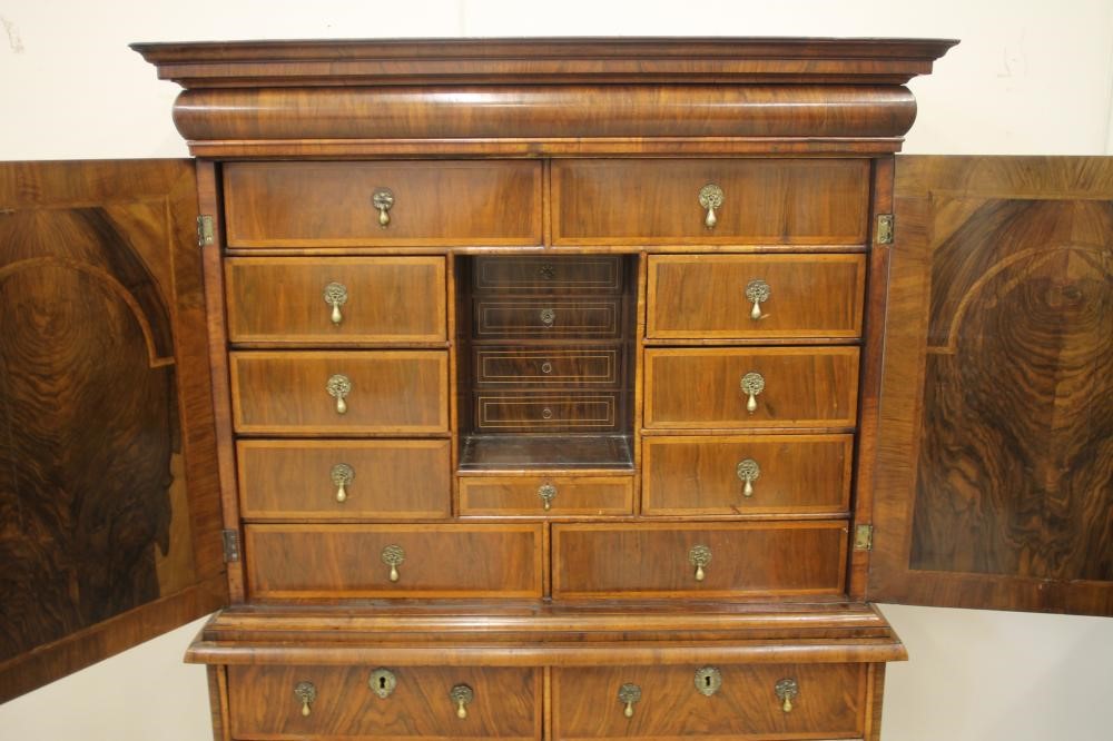 AN EARLY GEORGIAN AND LATER WALNUT AND FEATHER BANDED CABINET ON CHEST Image