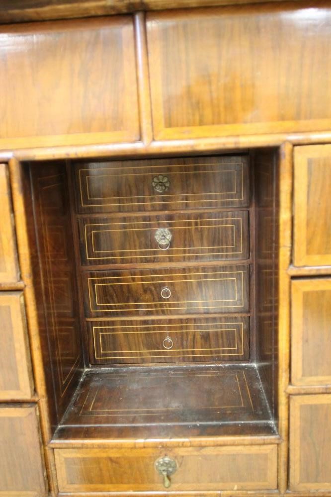 AN EARLY GEORGIAN AND LATER WALNUT AND FEATHER BANDED CABINET ON CHEST Image