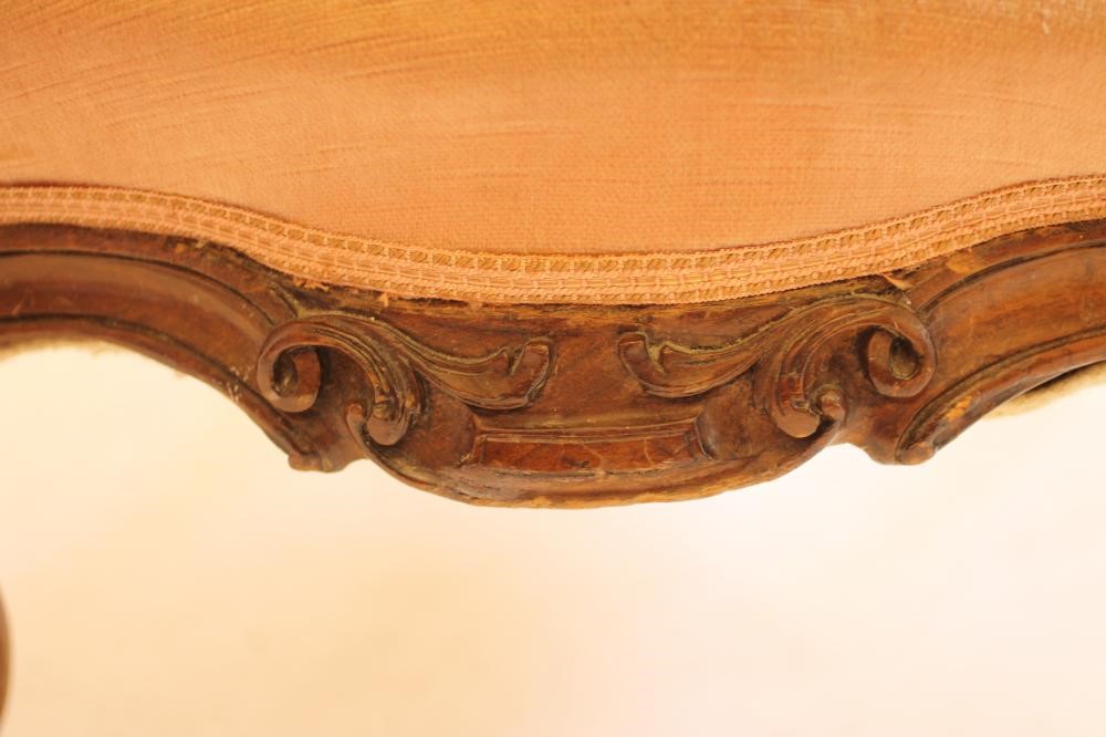 A VICTORIAN WALNUT FRAMED NURSING CHAIR of spoon back form upholstered in a pink velvet Image