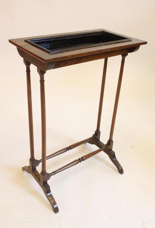 AN EDWARDIAN MAHOGANY AND ROSEWOOD VENEERED JARDINIERE STAND of oblong form with recessed centre Image