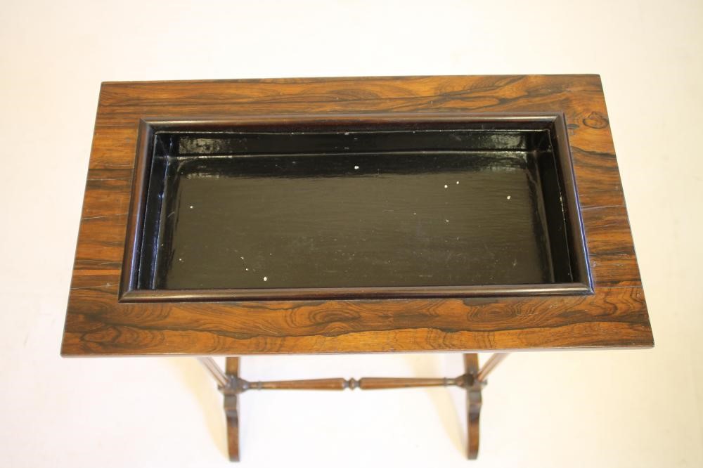 AN EDWARDIAN MAHOGANY AND ROSEWOOD VENEERED JARDINIERE STAND of oblong form with recessed centre Image