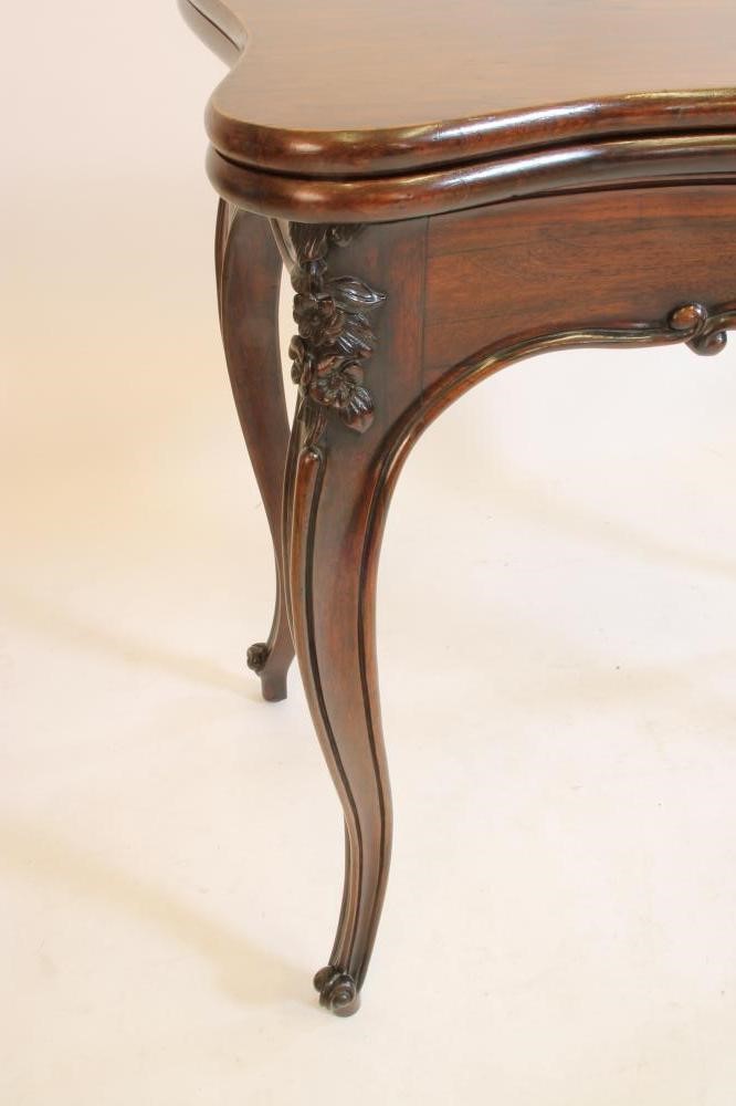 A VICTORIAN ROSEWOOD CARD TABLE of oblong serpentine form Image