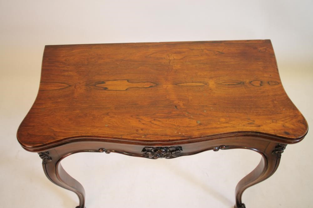 A VICTORIAN ROSEWOOD CARD TABLE of oblong serpentine form Image
