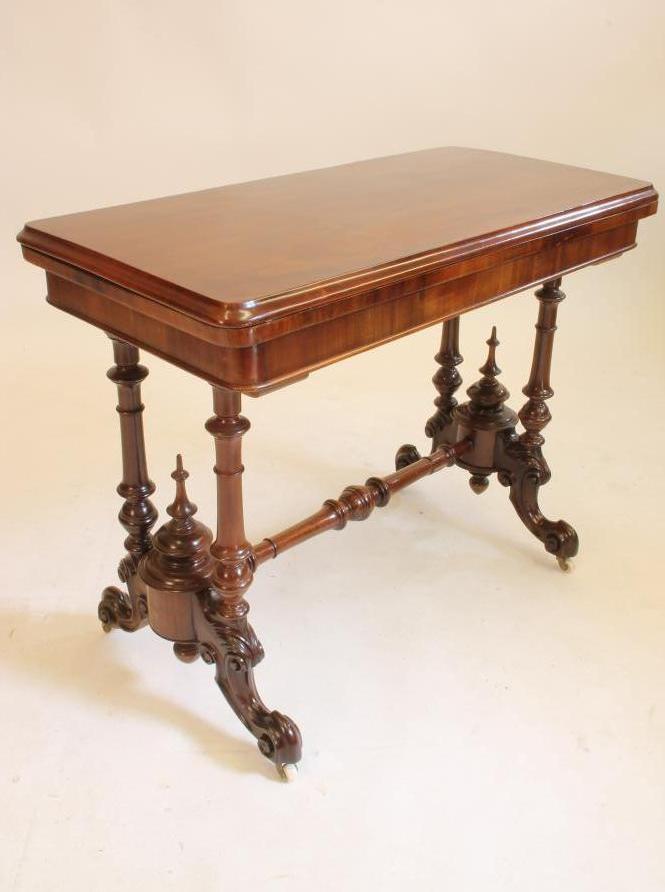A VICTORIAN MAHOGANY CARD TABLE of oblong pillar end form Image