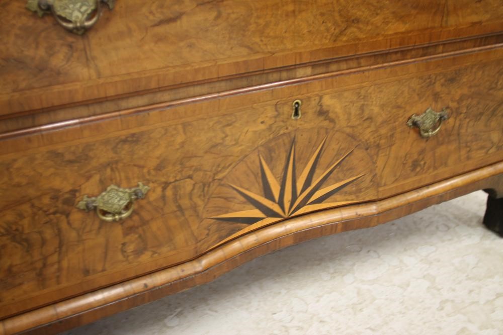 A GEORGIAN WALNUT AND FEATHER BANDED SECRETAIRE CHEST Image