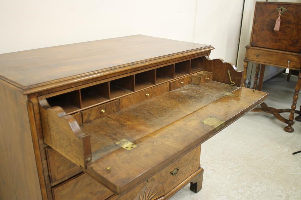 A GEORGIAN WALNUT AND FEATHER BANDED SECRETAIRE CHEST Image
