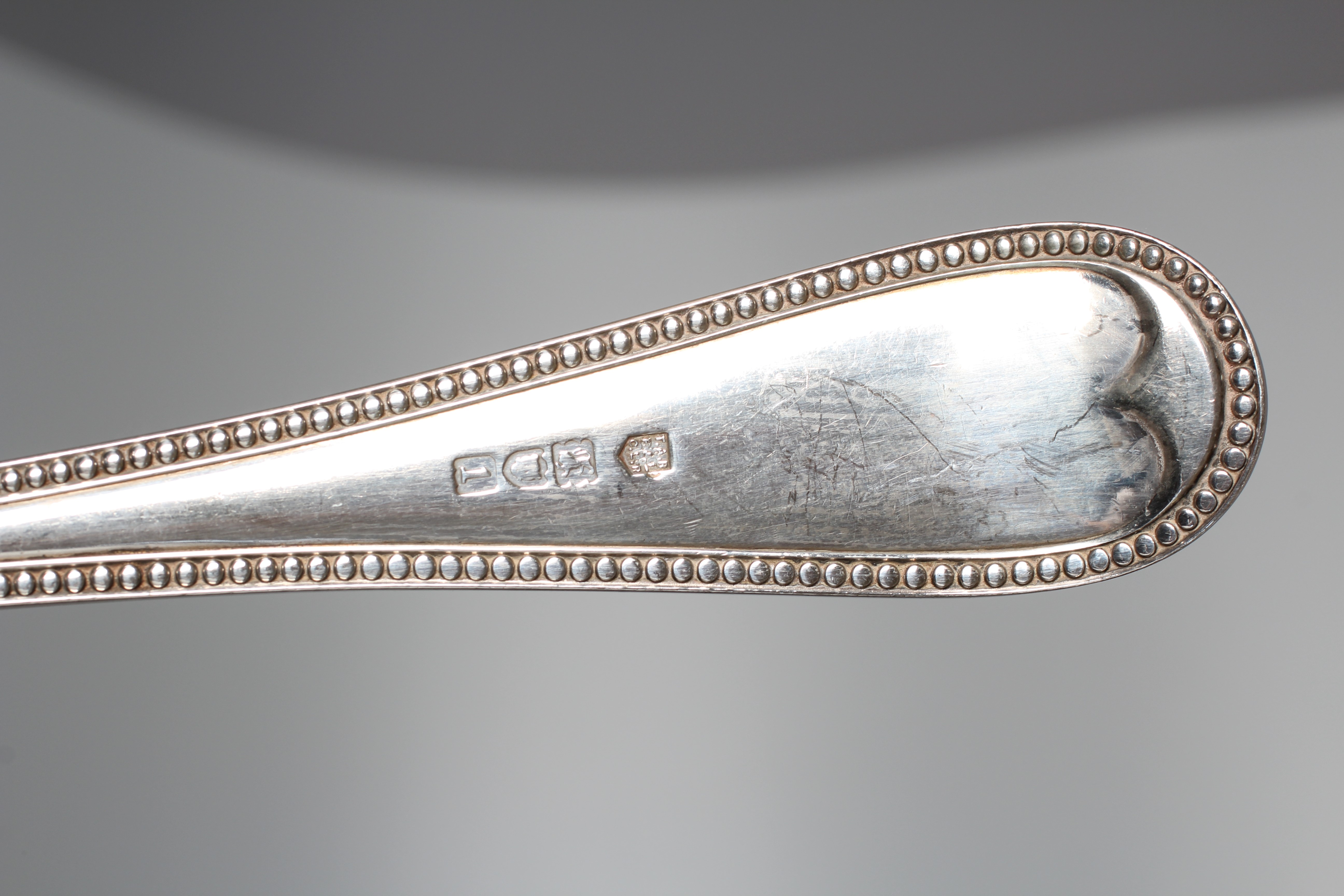AN EDWARD VII BEAD PATTERN SOUP LADLE by Reid & Sons, London 1906, 12" long, 9ozs 15dwts Image