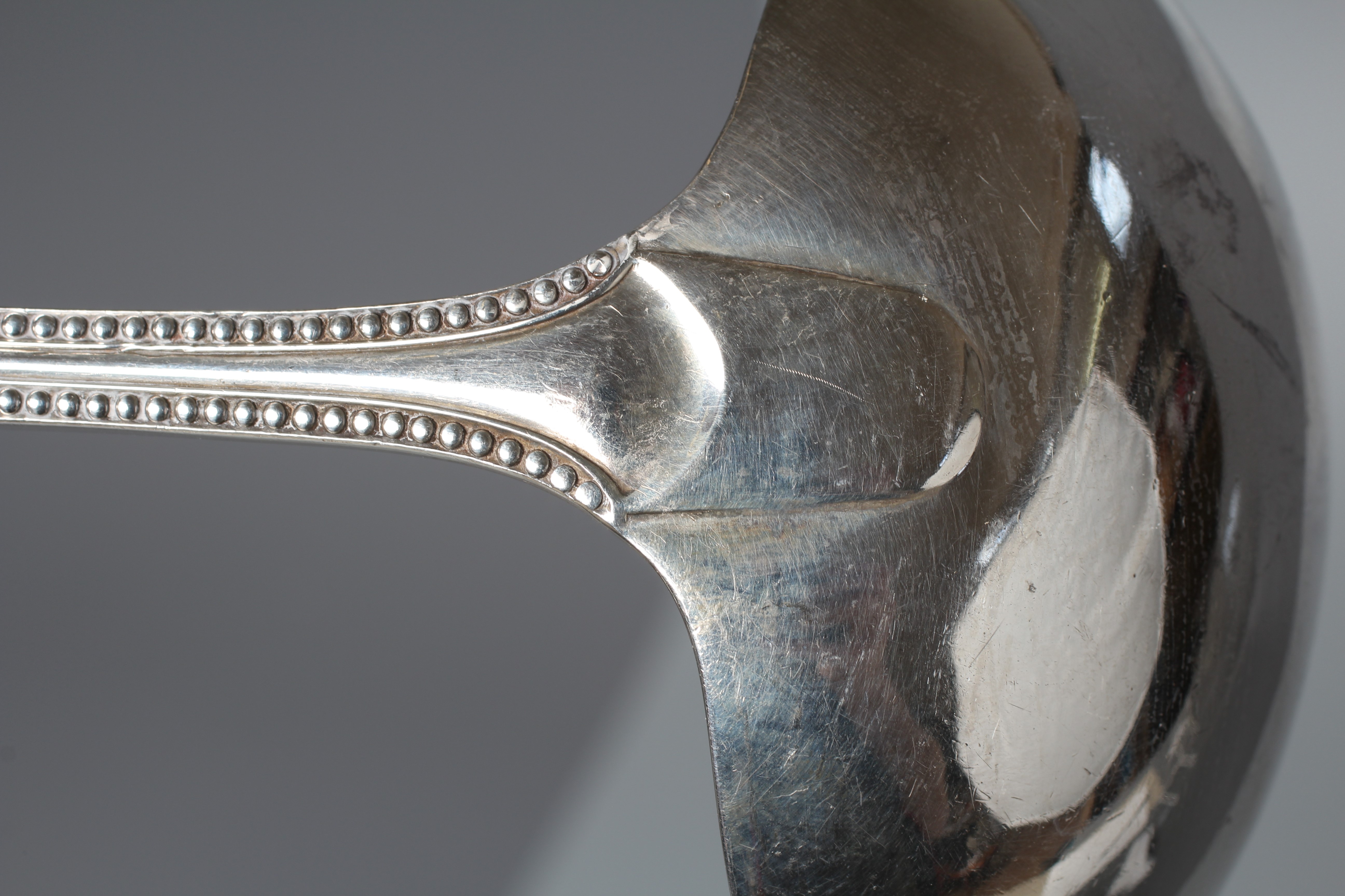 AN EDWARD VII BEAD PATTERN SOUP LADLE by Reid & Sons, London 1906, 12" long, 9ozs 15dwts Image