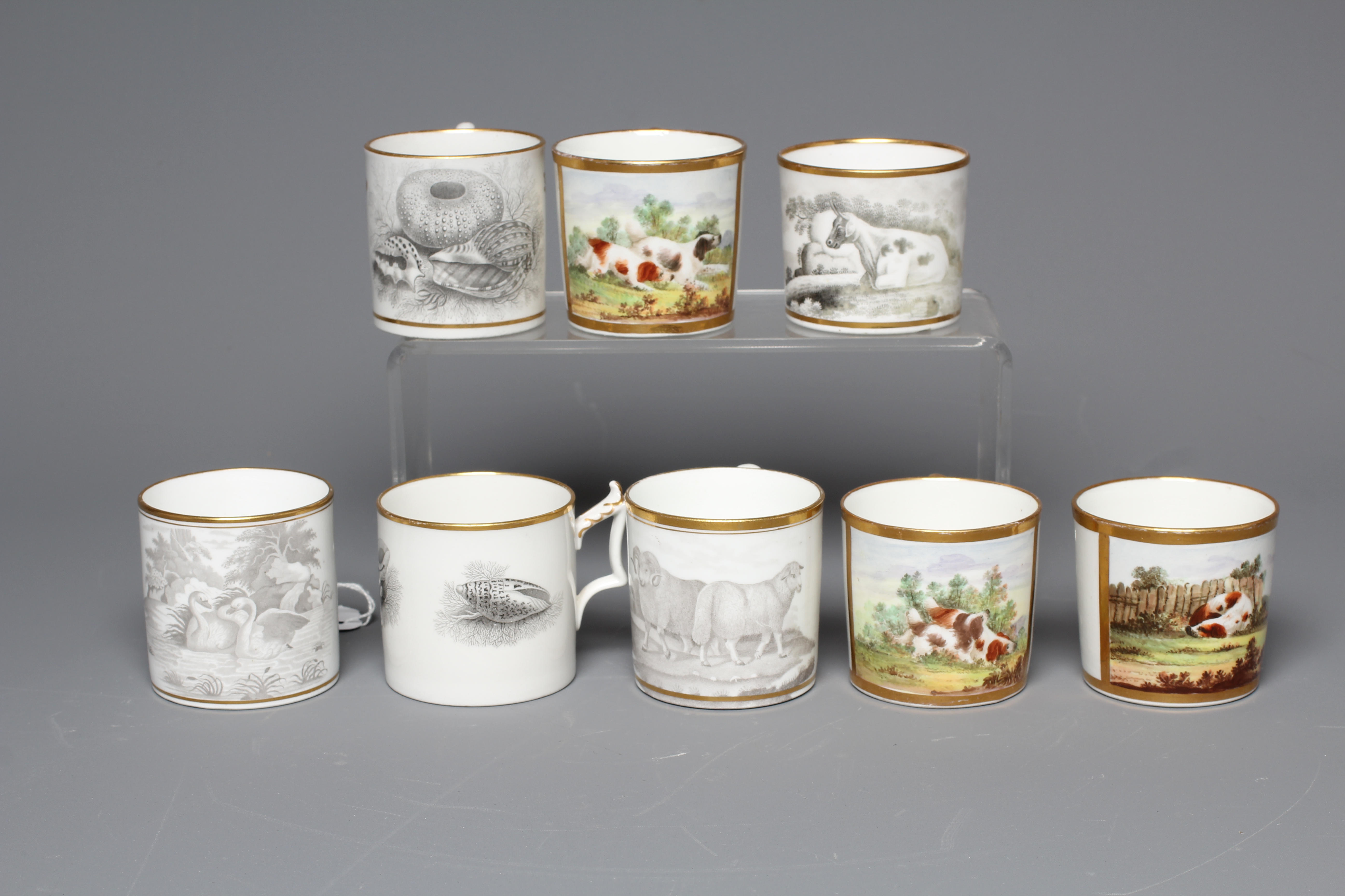 A SET OF THREE ENGLISH PORCELAIN COFFEE CANS painted in polychrome enamels with a gilt square panel Image
