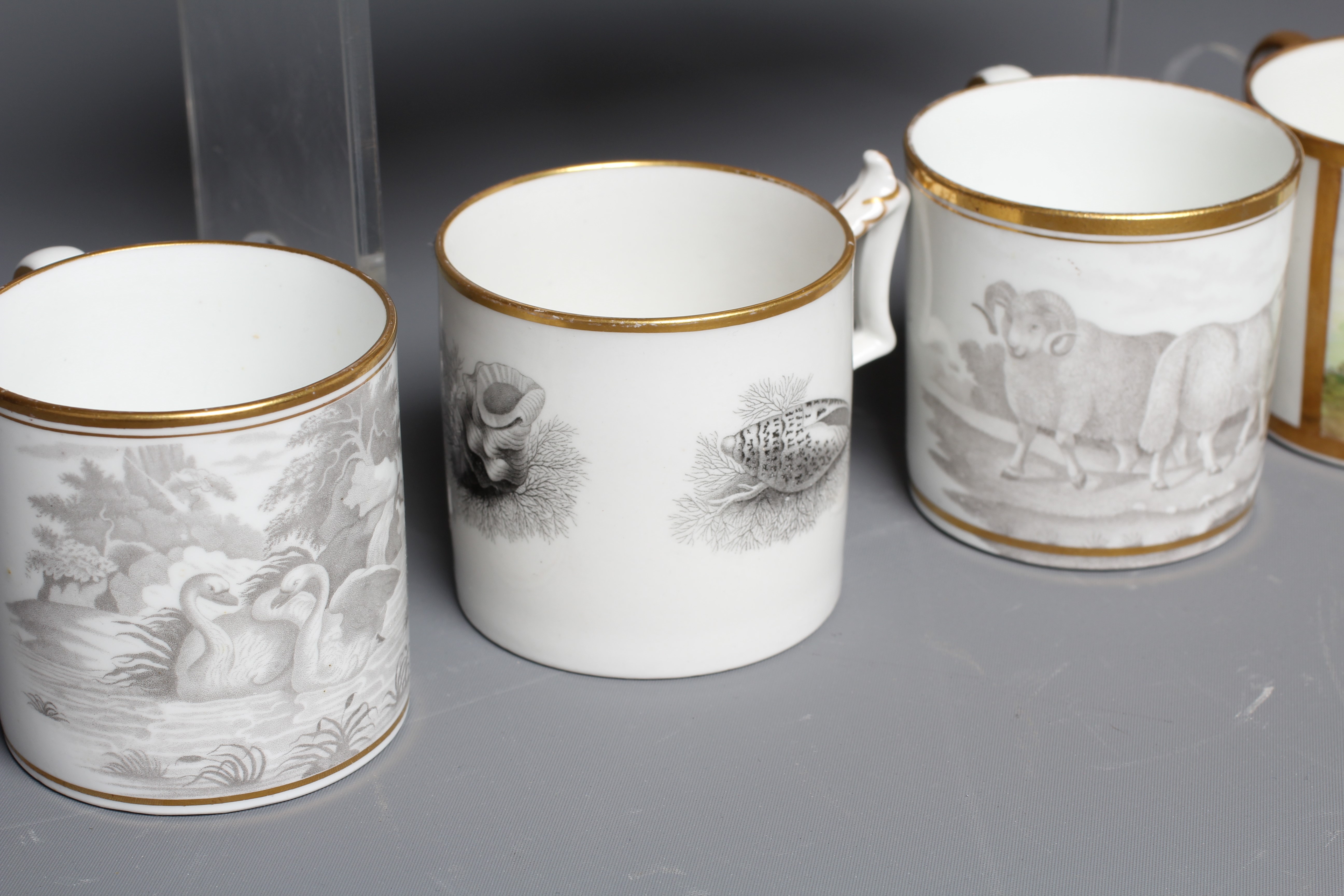 A SET OF THREE ENGLISH PORCELAIN COFFEE CANS painted in polychrome enamels with a gilt square panel Image