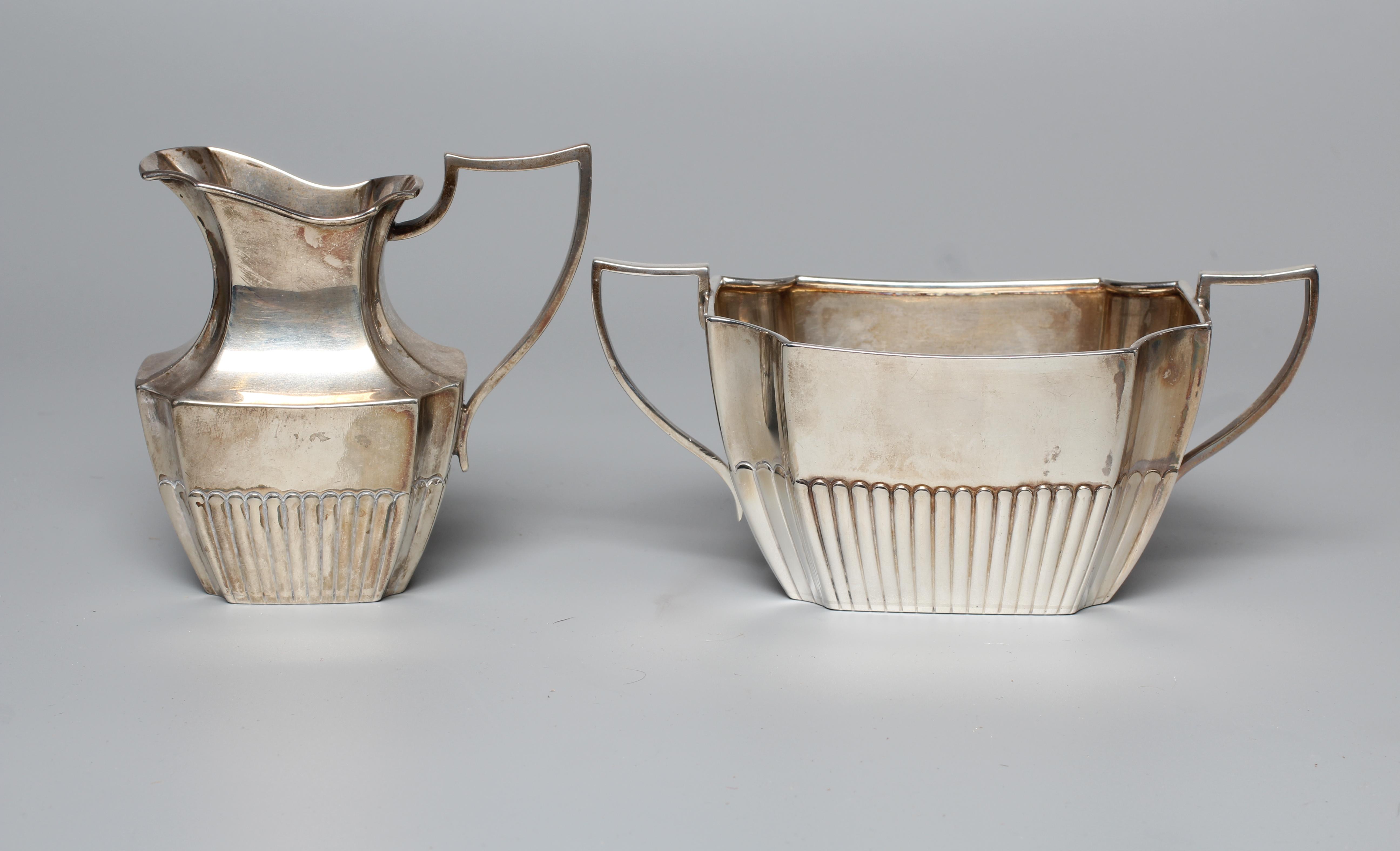 A LATE VICTORIAN MILK JUG AND SUGAR BASIN by William Hutton & Sons Ltd., London 1898, of semi fluted Image