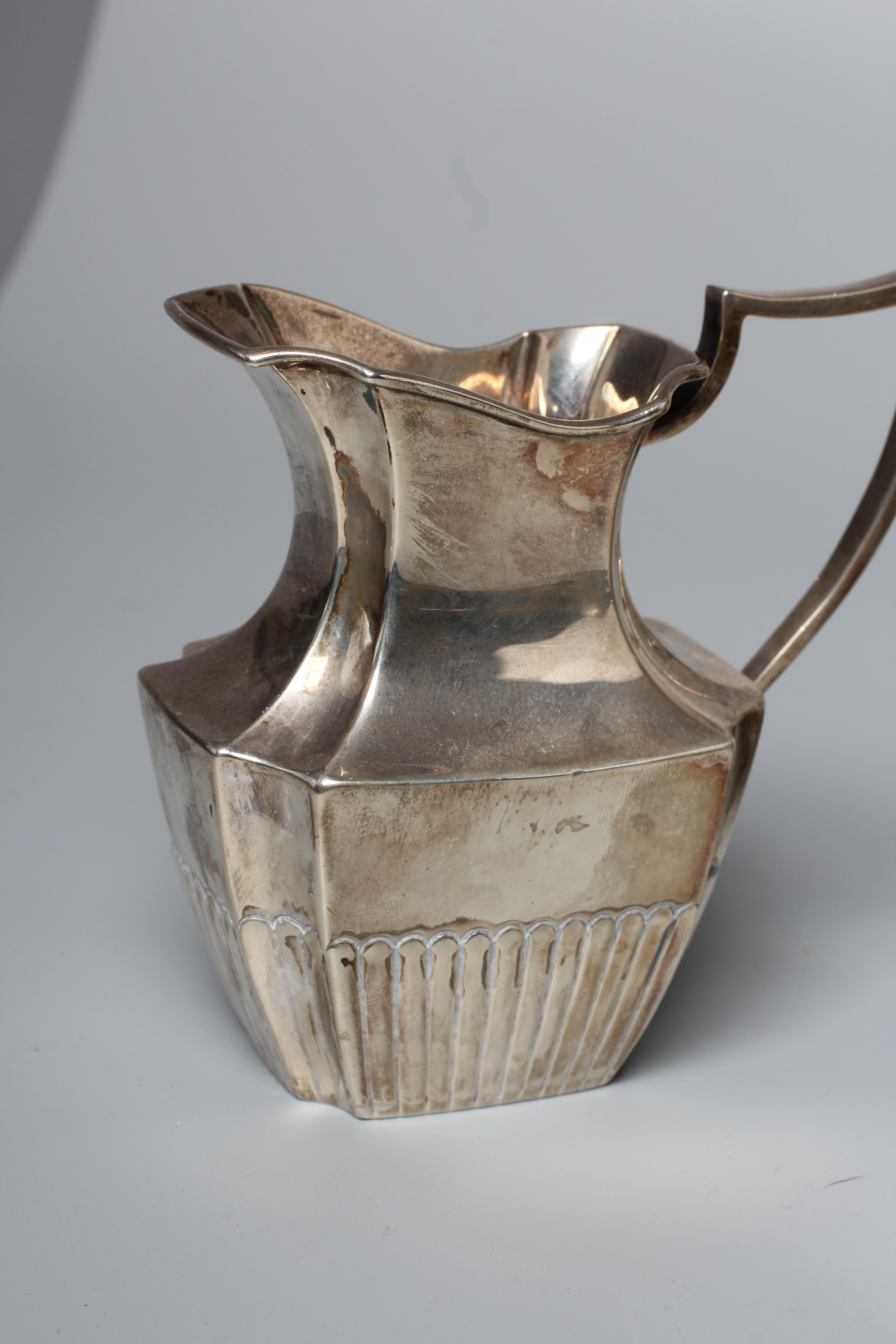 A LATE VICTORIAN MILK JUG AND SUGAR BASIN by William Hutton & Sons Ltd., London 1898, of semi fluted Image