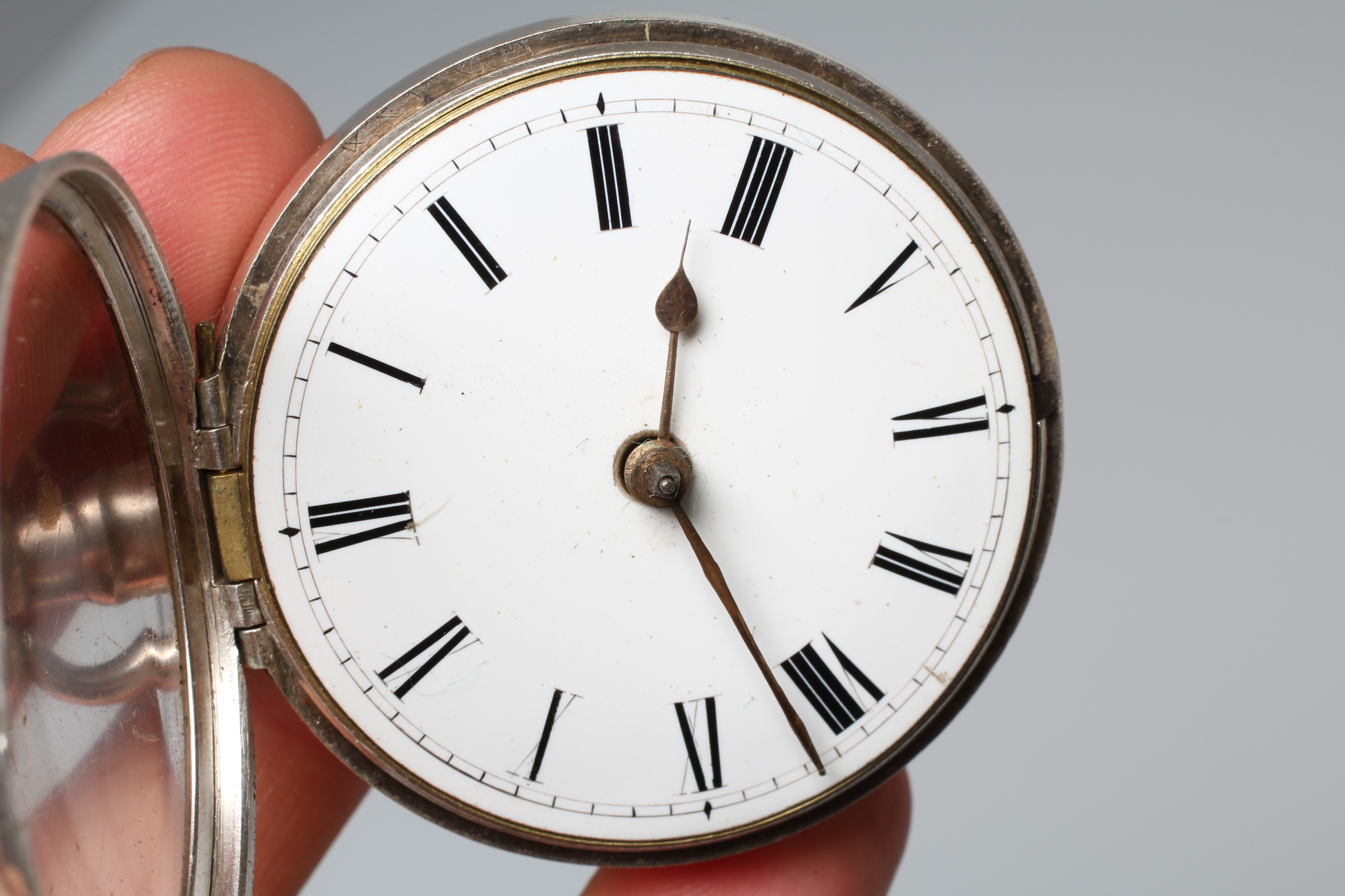 A SILVER PAIR CASED POCKET WATCH, the white dial with black Roman numerals, the verge movement with Image