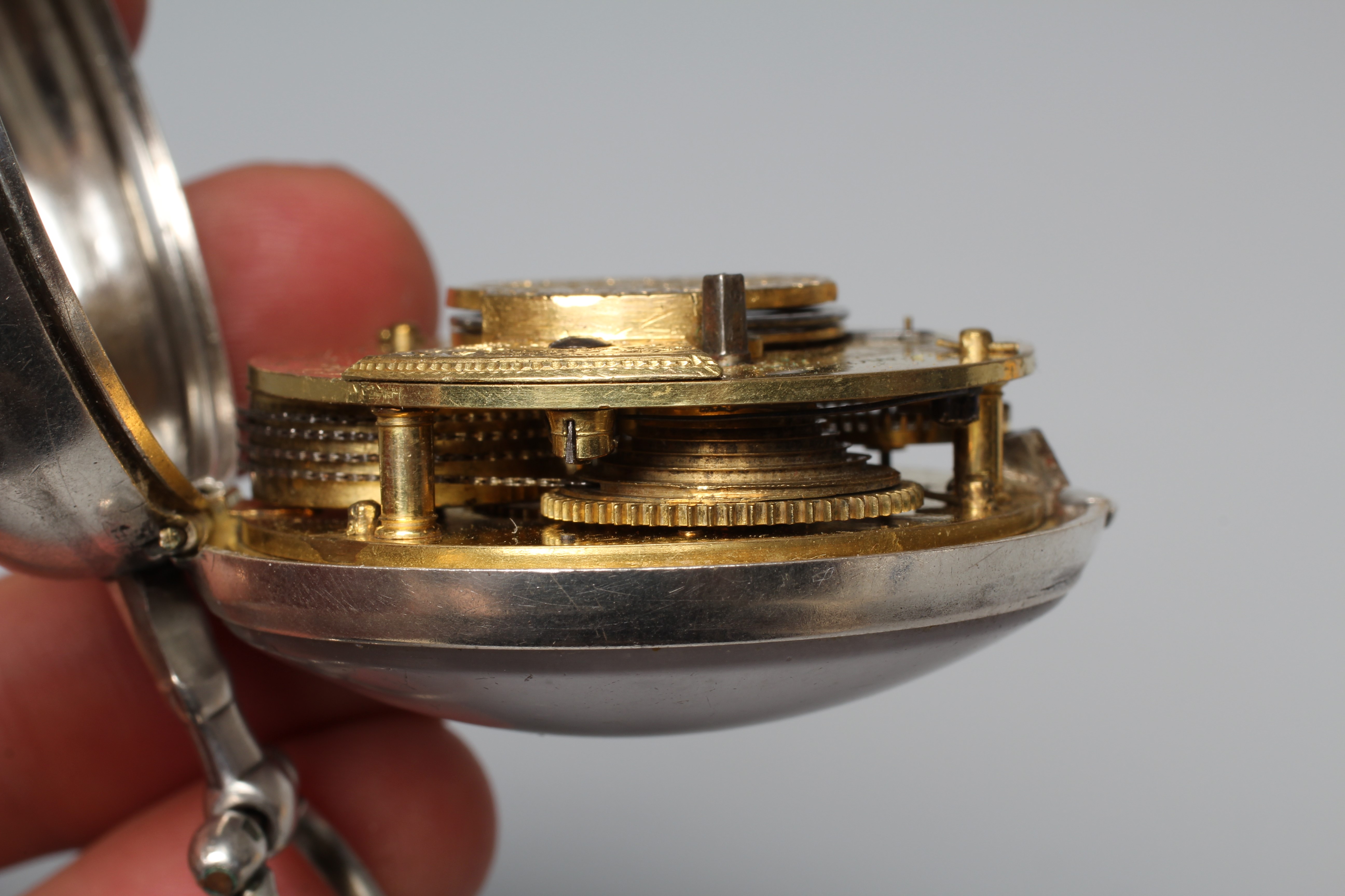 A SILVER PAIR CASED POCKET WATCH, the white dial with black Roman numerals, the verge movement with Image