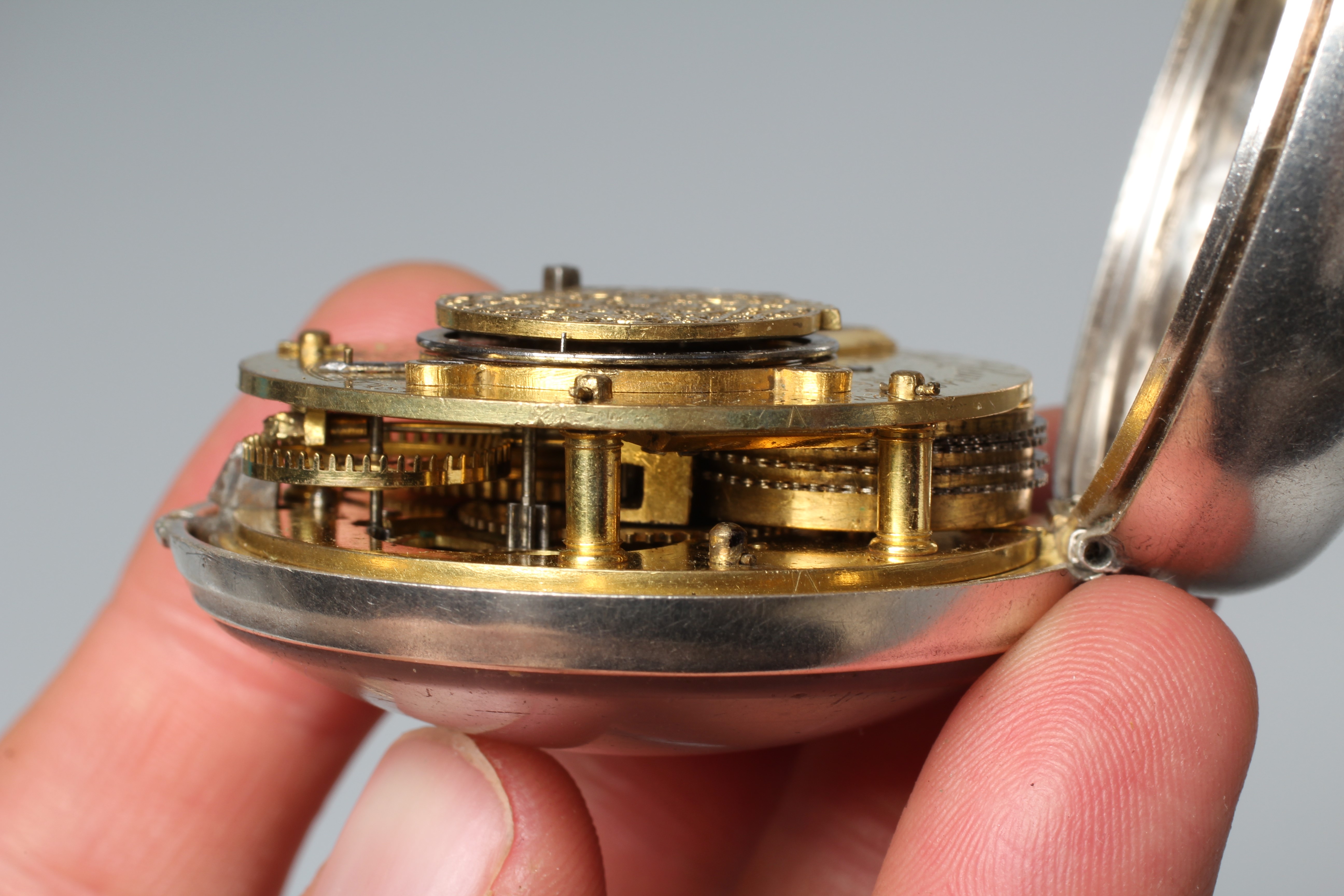 A SILVER PAIR CASED POCKET WATCH, the white dial with black Roman numerals, the verge movement with Image