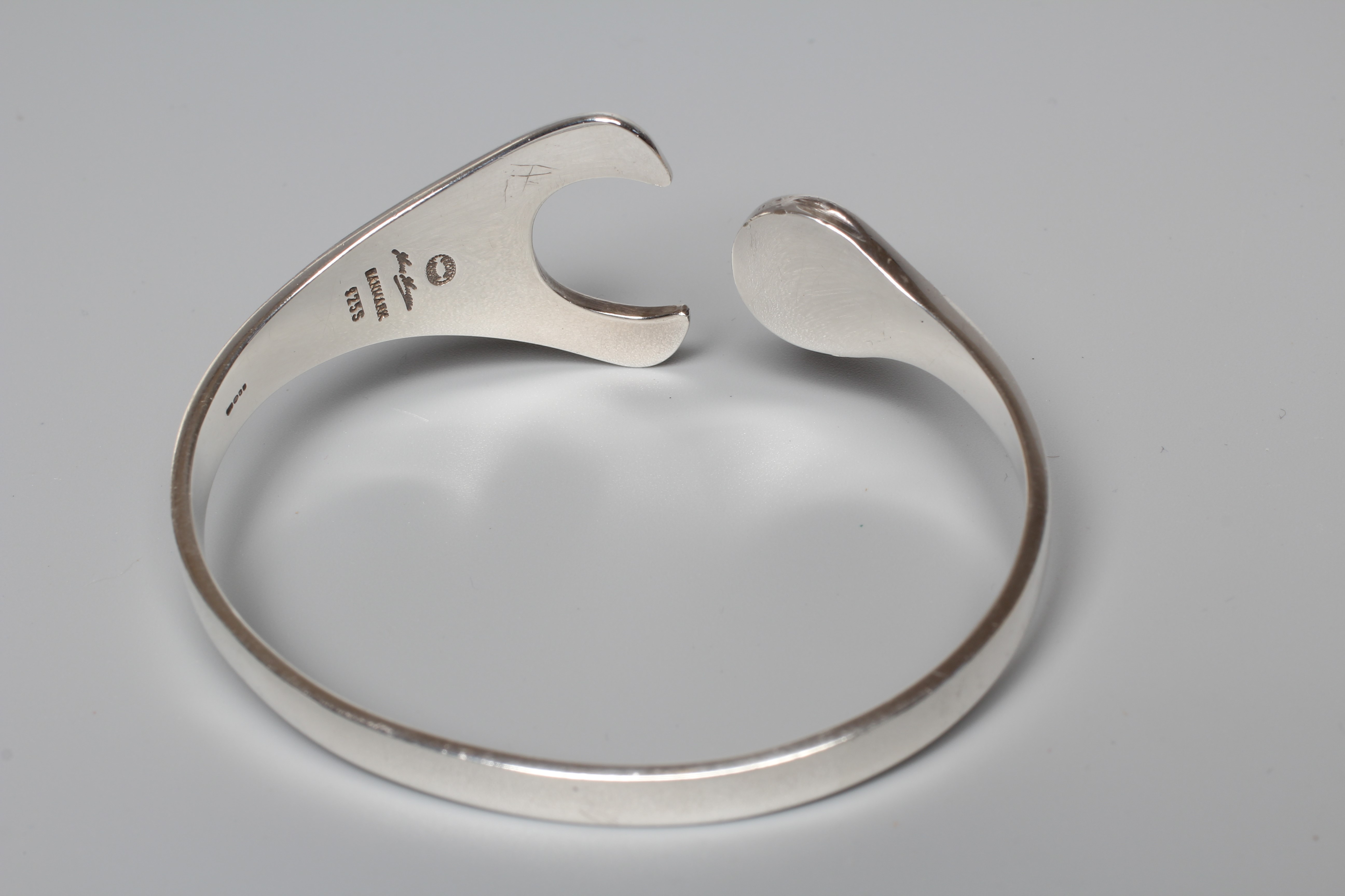 A GEORG JENSEN SILVER PUZZLE BANGLE designed by Hans Hansen, stamped 925, Danmark (Illustrated) Image