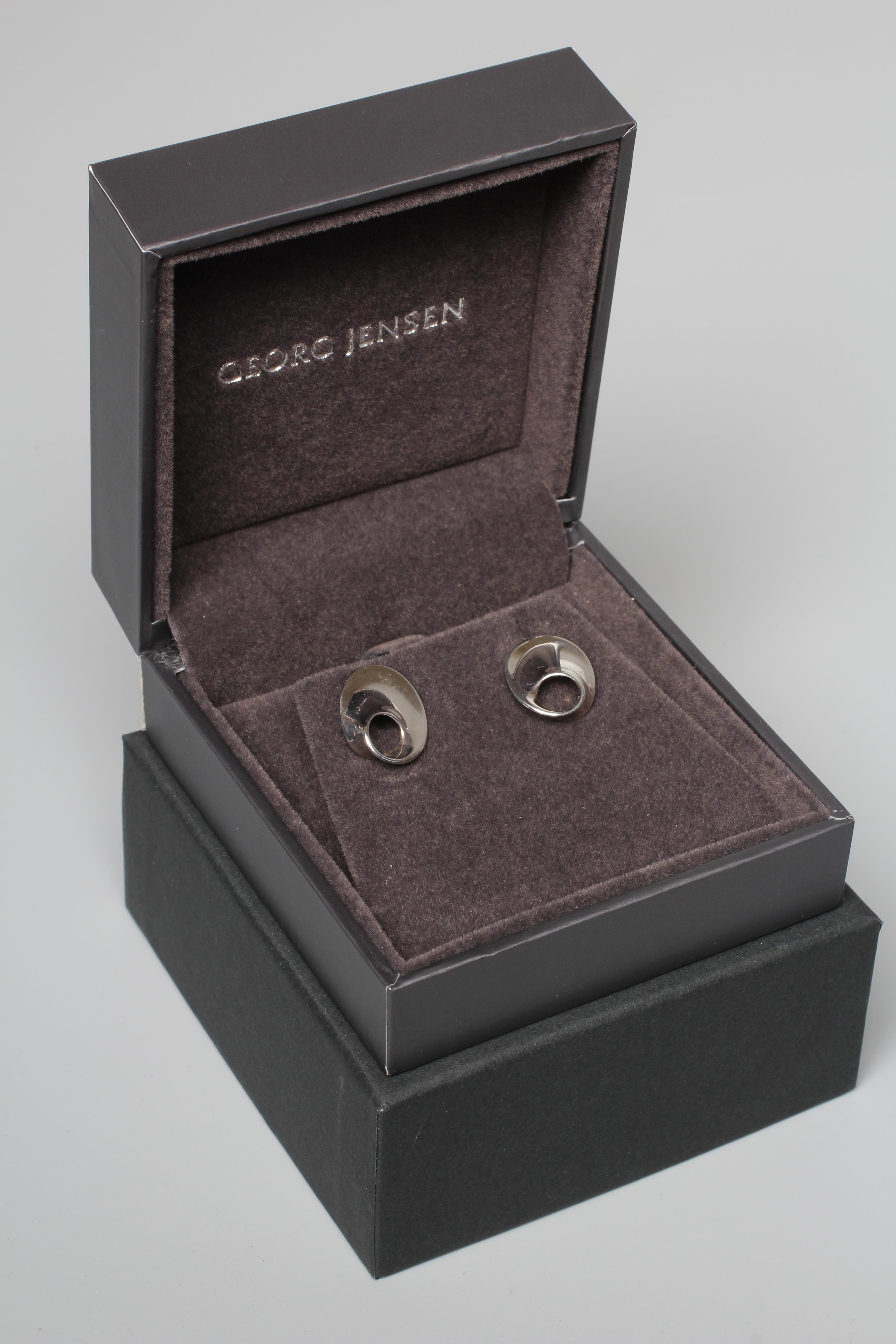 A PAIR OF GEORG JENSEN SILVER EAR STUDS designed by Vivianna Torun and realistically modelled as Image