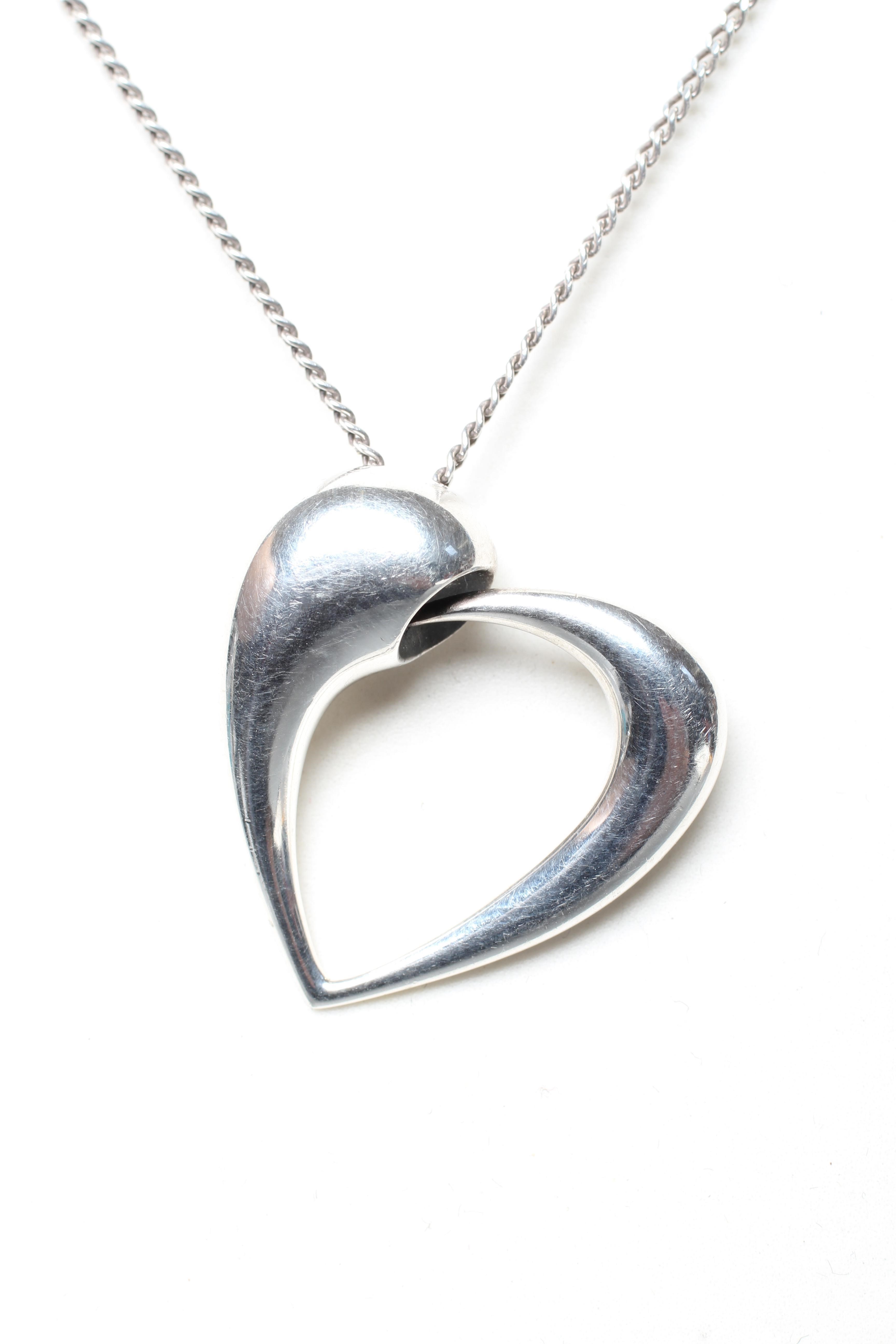 A GEORG JENSEN SILVER YEAR OF THE HEART PENDANT designed by Karim Rashid for Georg Jensen, on a Image