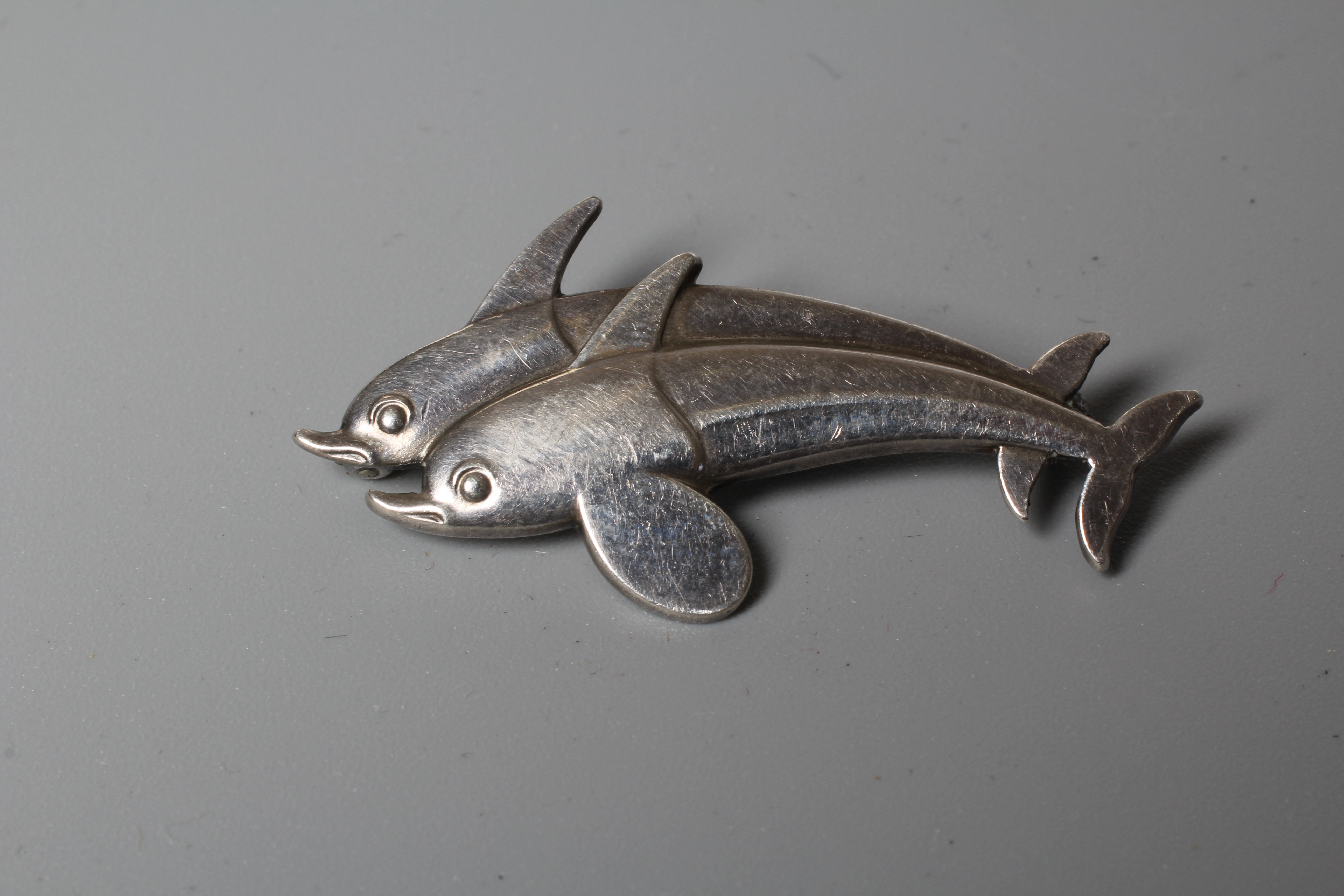 A GEORG JENSEN SILVER DOUBLE DOLPHIN BROOCH designed by Arno Malinowski, stamped and numbered 317 Image