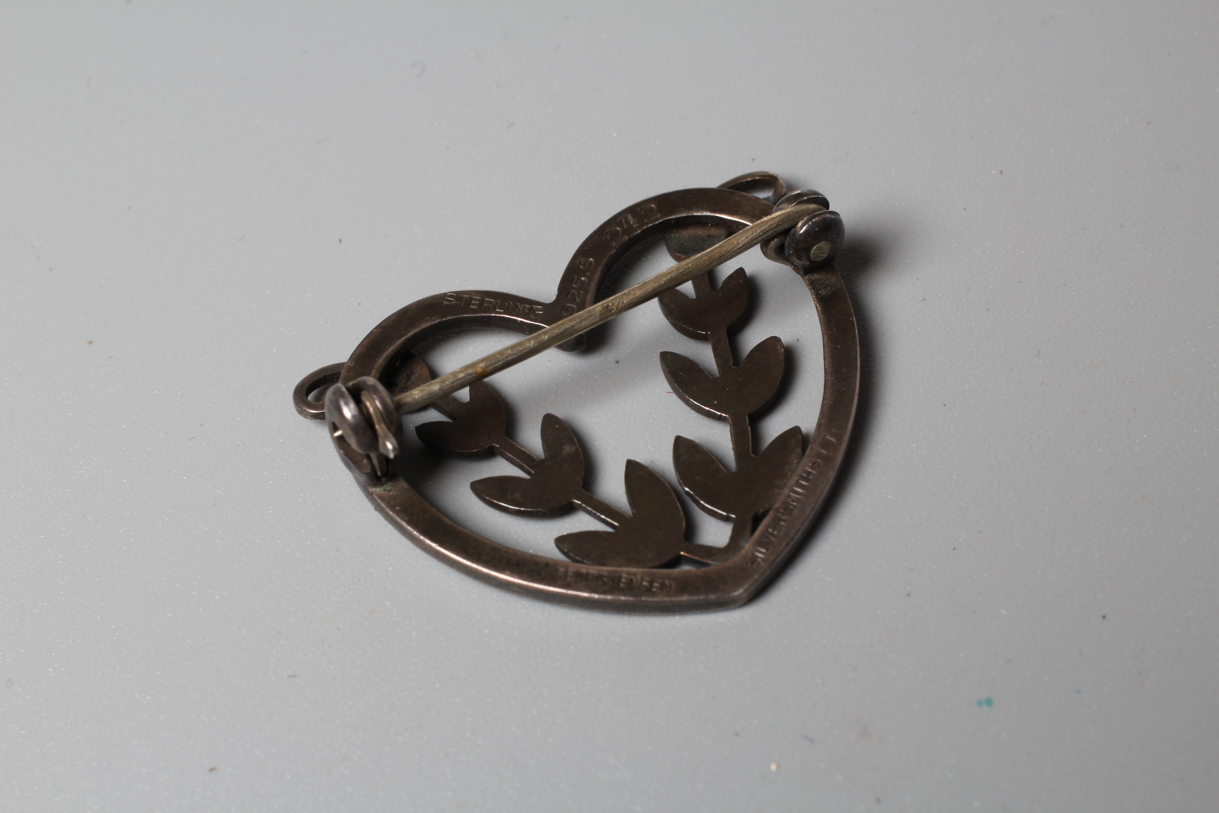 A GEORG JENSEN SILVER HEART BROOCH designed by Arno Malinowski, centred by two leafy fronds, stamped Image