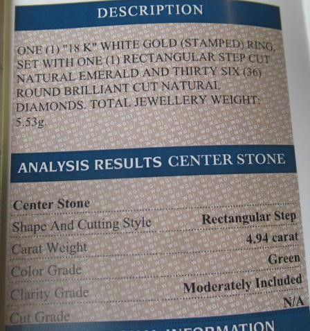 AN EMERALD AND DIAMOND CLUSTER RING Image