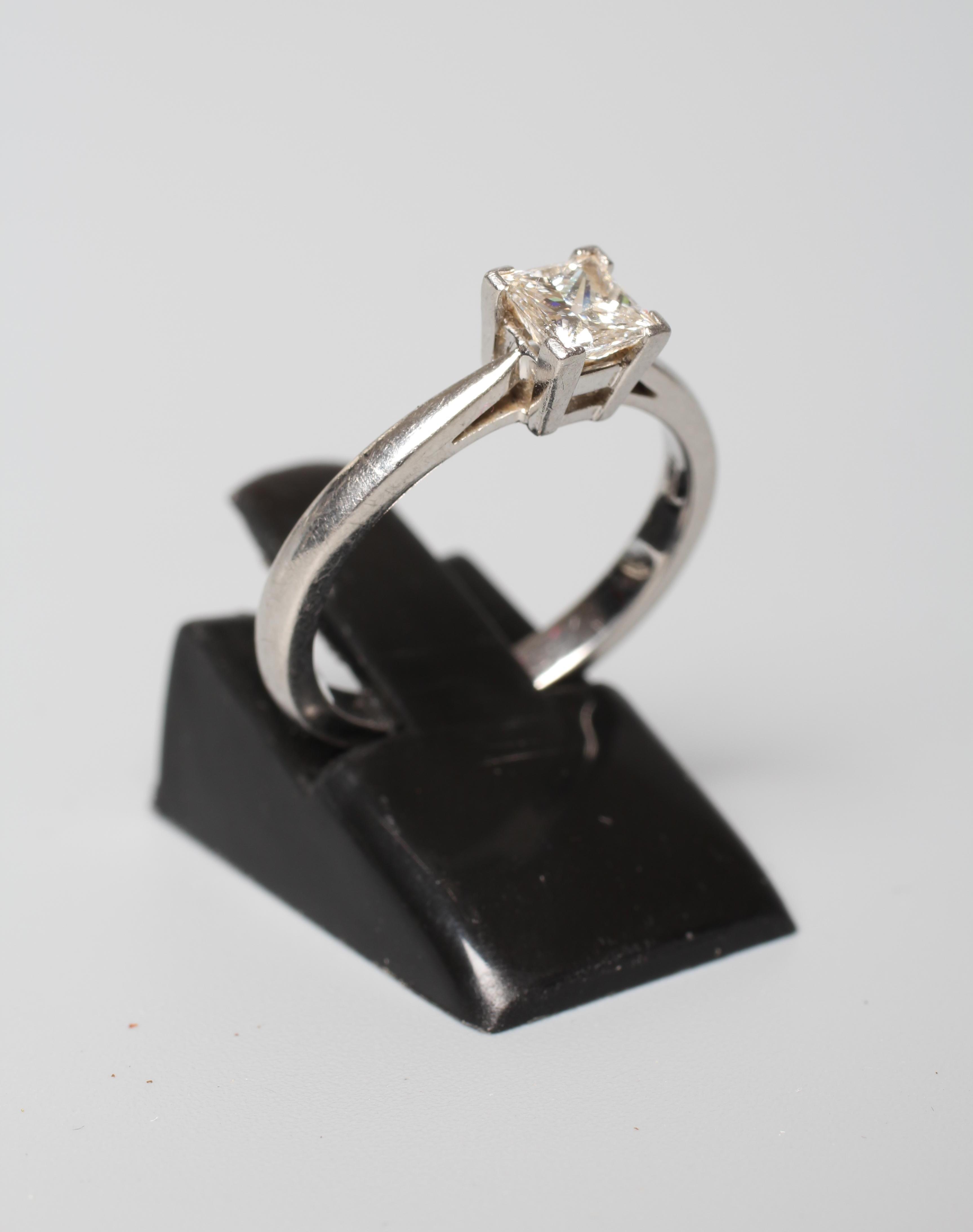 A SOLITAIRE DIAMOND RING, the Princess cut stone of approximately 0.5cts, claw set to a plain Image