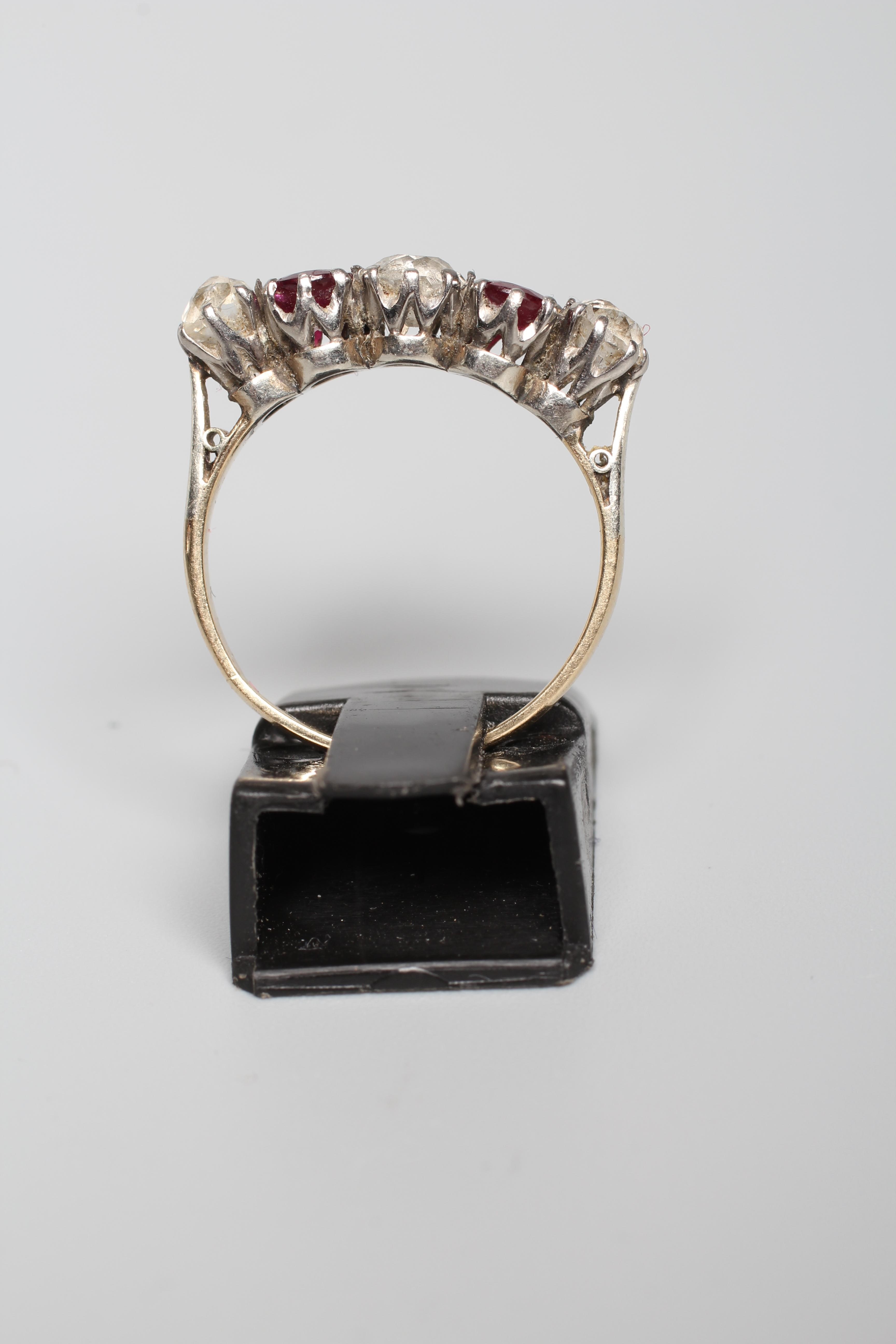 A RUBY AND DIAMOND FIVE STONE RING, the two oval facet cut rubies claw set with three graduating mix Image