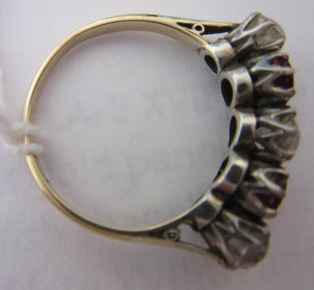A RUBY AND DIAMOND FIVE STONE RING, the two oval facet cut rubies claw set with three graduating mix Image